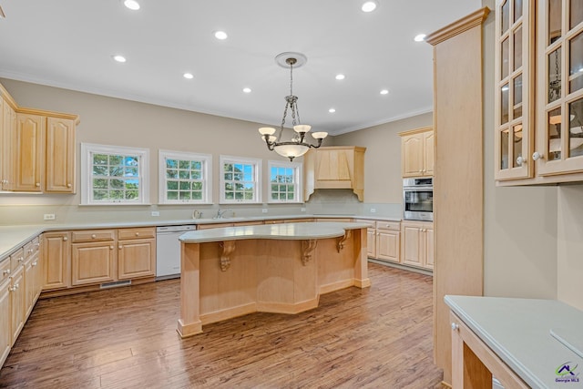 kitchen with dishwasher, light brown cabinets, and oven