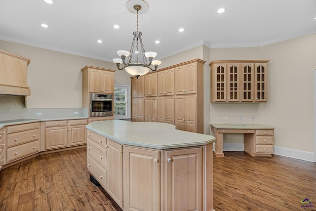 kitchen featuring light countertops, stainless steel oven, glass insert cabinets, light brown cabinets, and dark wood-style flooring