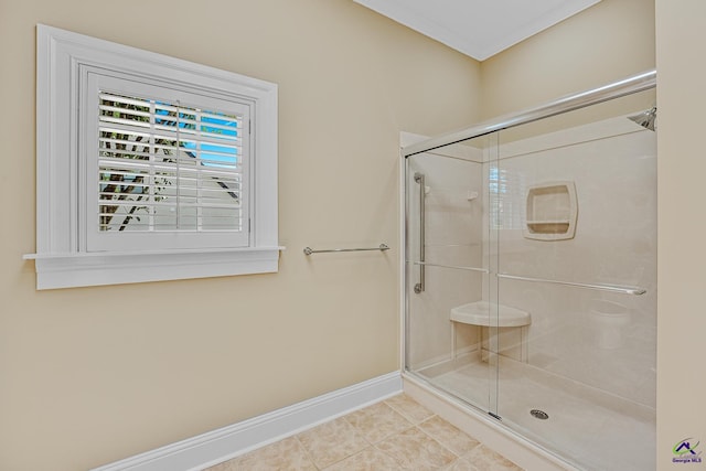 full bathroom featuring a shower stall, baseboards, and tile patterned floors