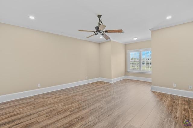 empty room with crown molding, recessed lighting, light wood-type flooring, baseboards, and ceiling fan