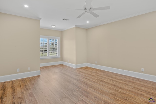 empty room featuring crown molding, light wood-style floors, ceiling fan, and baseboards