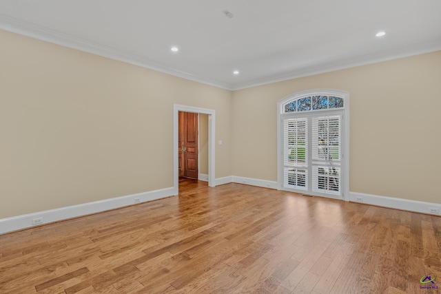 spare room featuring recessed lighting, crown molding, light wood-style floors, and baseboards