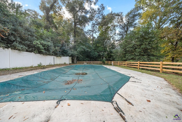 view of swimming pool featuring a fenced backyard