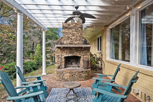 view of patio with an outdoor stone fireplace and a ceiling fan