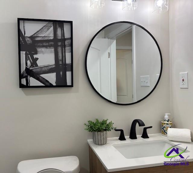 bathroom featuring toilet and vanity