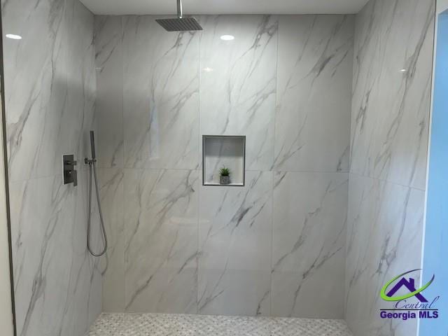 bathroom with a marble finish shower