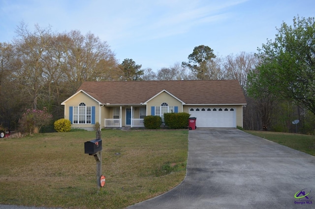 ranch-style home with roof with shingles, driveway, an attached garage, a front yard, and a porch