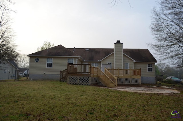 rear view of property featuring a chimney, a wooden deck, stairs, and a lawn