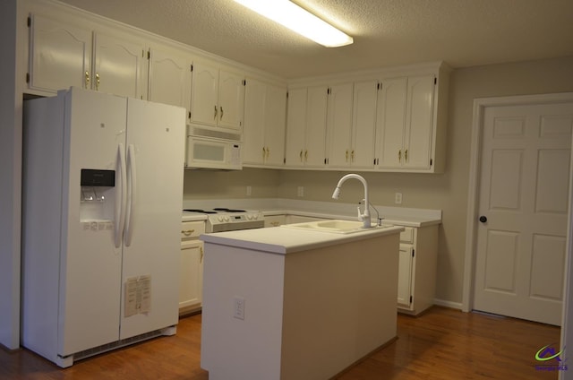 kitchen featuring a sink, white cabinetry, and white appliances