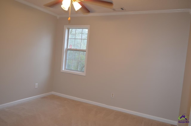 unfurnished room with visible vents, baseboards, ornamental molding, a ceiling fan, and light carpet