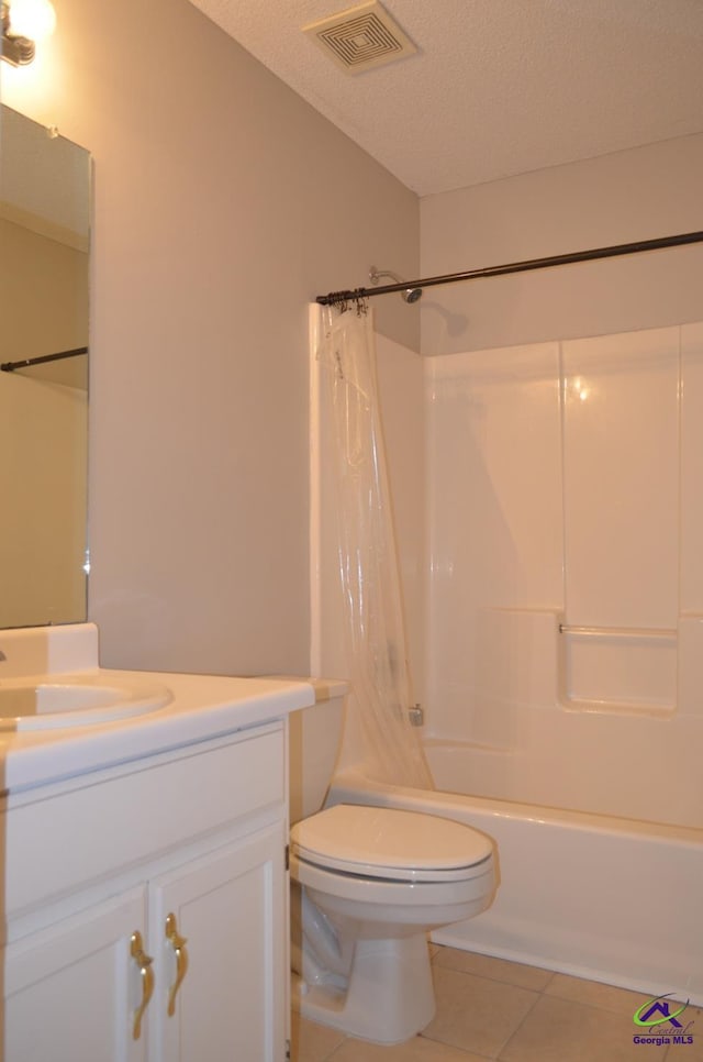 full bath featuring vanity, tile patterned flooring, a textured ceiling, visible vents, and shower / bath combo with shower curtain
