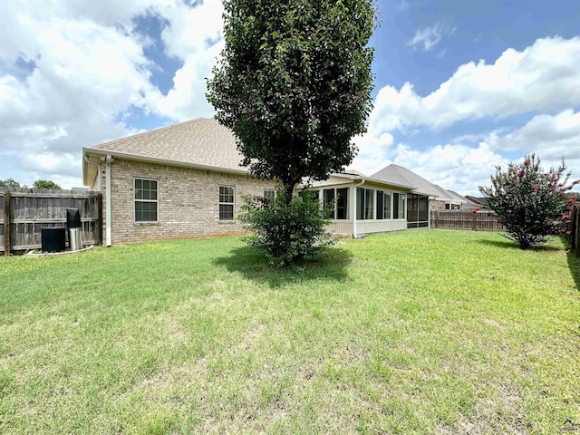 100 Northumberland Way, Warner Robins, GA 31088 - rear view of house featuring brick siding, a sunroom, and a shingled roof