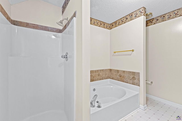 bathroom with a bath, a textured ceiling, a walk in shower, and tile patterned floors