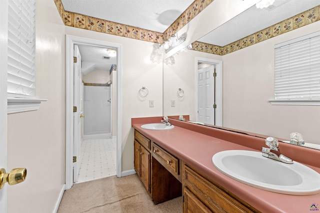 full bath with double vanity, a sink, baseboards, and walk in shower