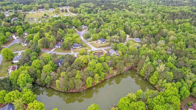 bird's eye view with a water view and a forest view