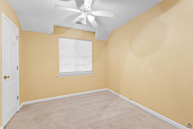 carpeted empty room with visible vents, ceiling fan, and baseboards