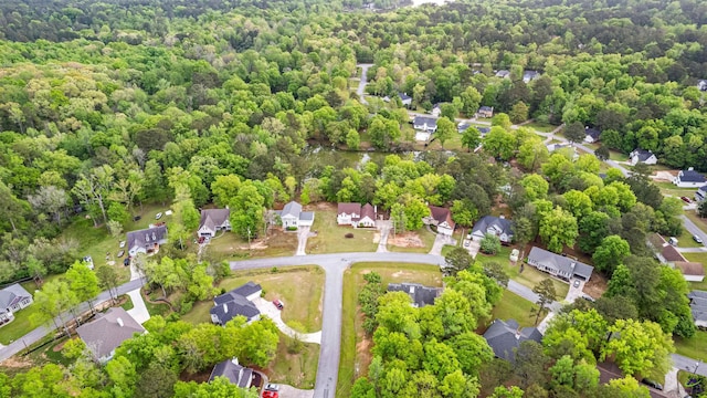 bird's eye view featuring a forest view and a residential view