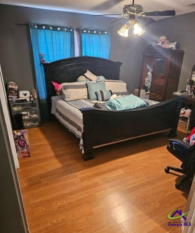 bedroom with wood finished floors and ceiling fan