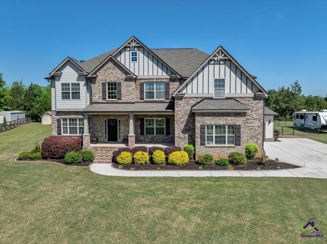159 Feather Ln, Jackson, GA 30233 - view of front of house with board and batten siding, fence, a front lawn, and brick siding