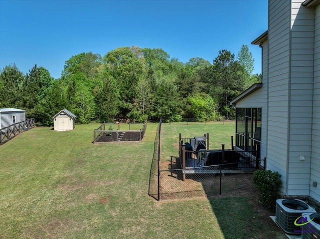 159 Feather Ln, Jackson, GA 30233 - view of yard featuring an outbuilding, a storage shed, a garden, fence, and central AC unit