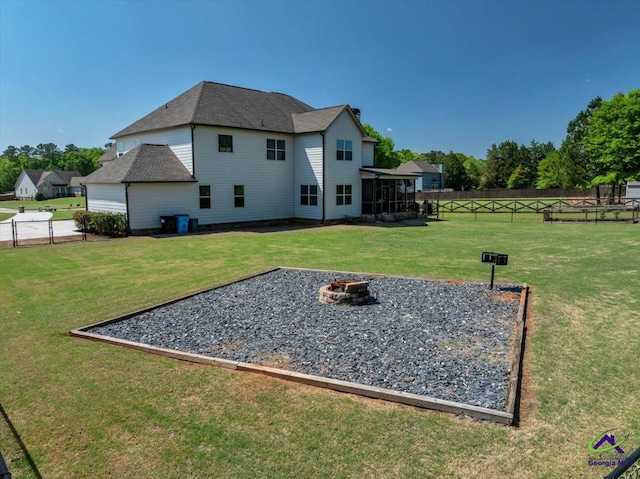 159 Feather Ln, Jackson, GA 30233 - back of property with a sunroom, a fire pit, fence private yard, and a lawn