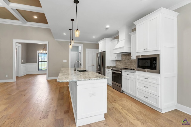 kitchen featuring crown molding, appliances with stainless steel finishes, custom exhaust hood, and a sink