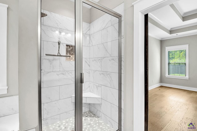 full bath featuring crown molding, baseboards, a shower stall, and wood finished floors
