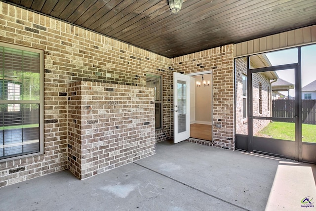 unfurnished sunroom with a wealth of natural light and a notable chandelier