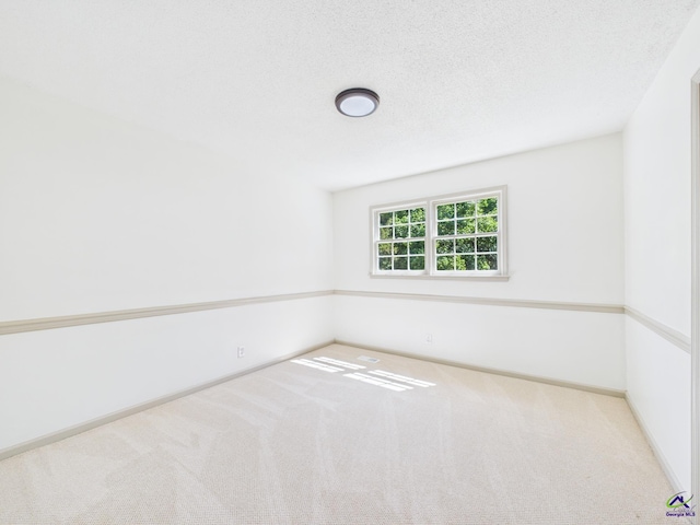 spare room featuring baseboards and carpet flooring