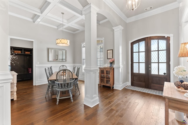 entryway featuring decorative columns, dark wood-type flooring, arched walkways, coffered ceiling, and french doors