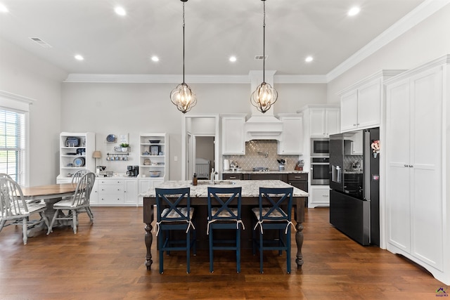 kitchen with white cabinetry, ornamental molding, visible vents, and stainless steel appliances