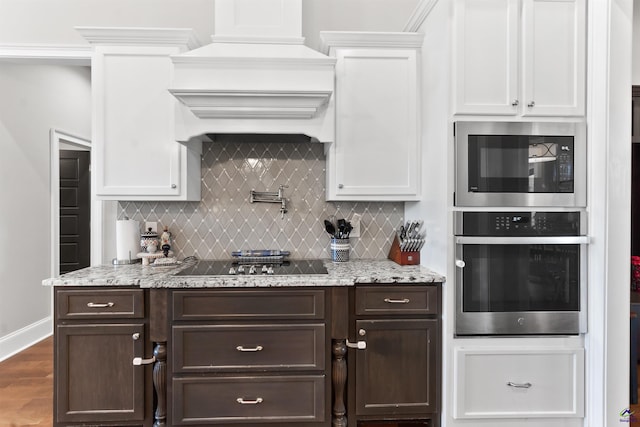 kitchen with custom exhaust hood, appliances with stainless steel finishes, dark brown cabinetry, and white cabinetry
