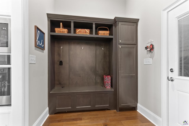 mudroom with baseboards and light wood-style floors