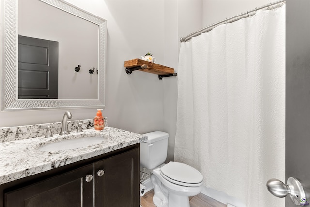 full bathroom with a shower with shower curtain, vanity, toilet, and wood finished floors
