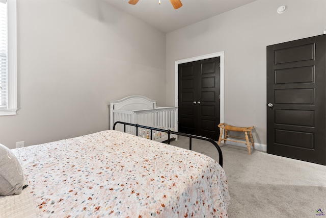 carpeted bedroom with baseboards and a ceiling fan