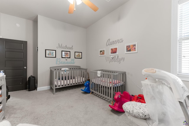 carpeted bedroom featuring baseboards and a ceiling fan