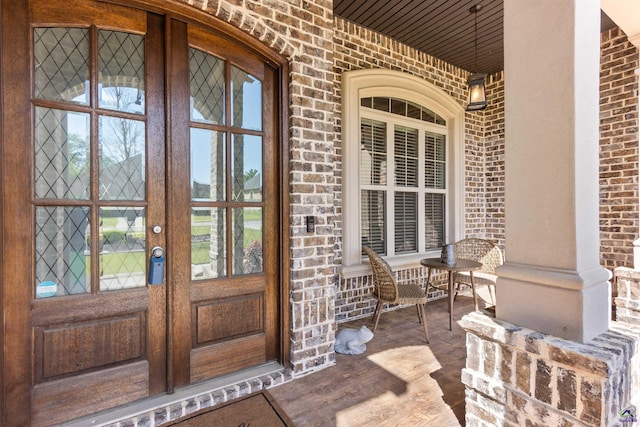 property entrance with a porch and french doors