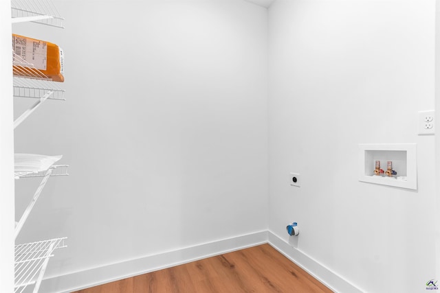 laundry area featuring washer hookup, wood finished floors, electric dryer hookup, and baseboards
