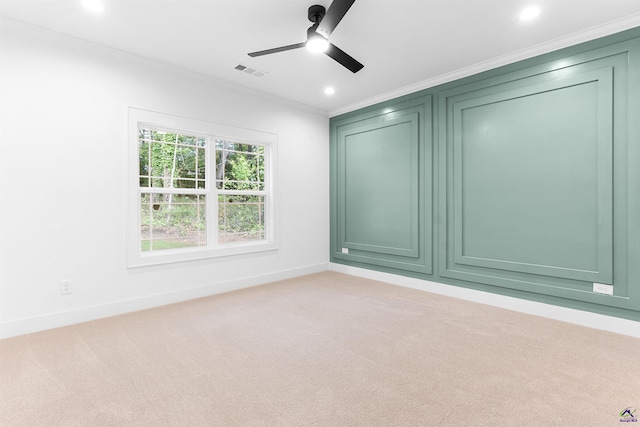 empty room with crown molding, a ceiling fan, light carpet, baseboards, and recessed lighting
