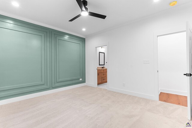 unfurnished bedroom featuring crown molding, light colored carpet, recessed lighting, baseboards, and ensuite bath