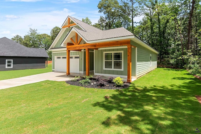 view of front of property with board and batten siding, an attached garage, driveway, and a front yard