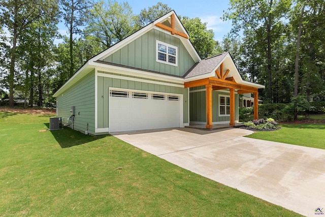 craftsman house featuring board and batten siding, central AC, a front yard, and concrete driveway