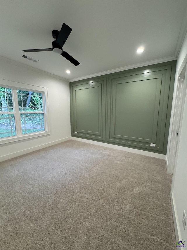 unfurnished room featuring ceiling fan, crown molding, light colored carpet, baseboards, and recessed lighting
