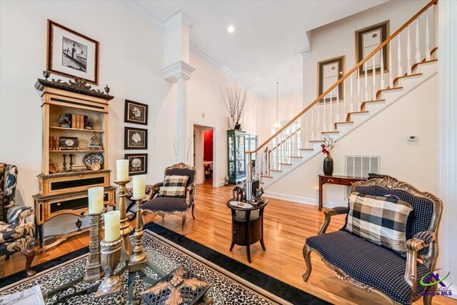 160 Barrington Hall Dr, Macon, GA 31220 - living area featuring visible vents, crown molding, ornate columns, wood finished floors, and stairs