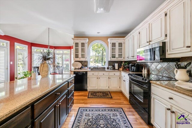 160 Barrington Hall Dr, Macon, GA 31220 - kitchen featuring glass insert cabinets, black appliances, a sink, light wood finished floors, and backsplash