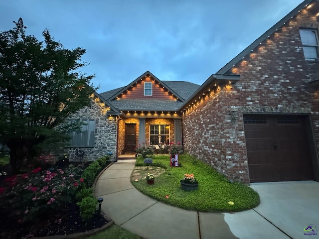 view of front of house featuring driveway and brick siding