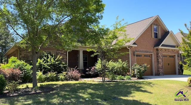 105 Grand View Ave, Kathleen, GA 31047 - view of front facade with a front lawn, stone siding, concrete driveway, brick siding, and a garage