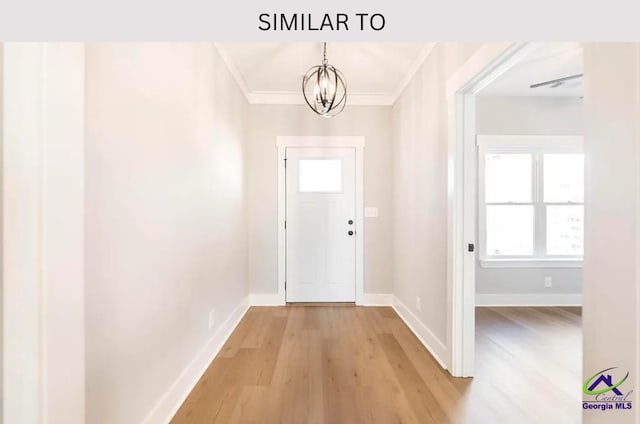 104 Reedy Ct, Perry, GA 31069 - doorway with a chandelier, light wood-style flooring, baseboards, and ornamental molding