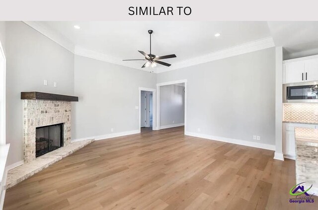 104 Reedy Ct, Perry, GA 31069 - unfurnished living room featuring a fireplace, a ceiling fan, ornamental molding, light wood finished floors, and baseboards