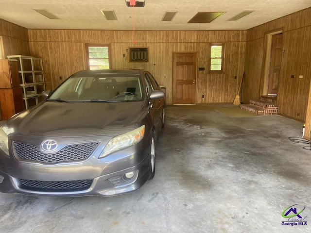 5864 Porterfield Cir, Macon, GA 31216 - garage featuring wooden walls and a garage door opener